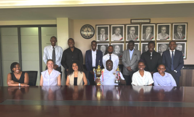 Group photo of Professor Ronald Naluwairo, Dean-SoL (holding trophies) with moot teams and staff